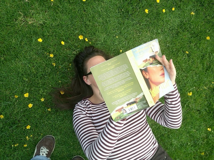 Reading Yesteryear lying in the grass