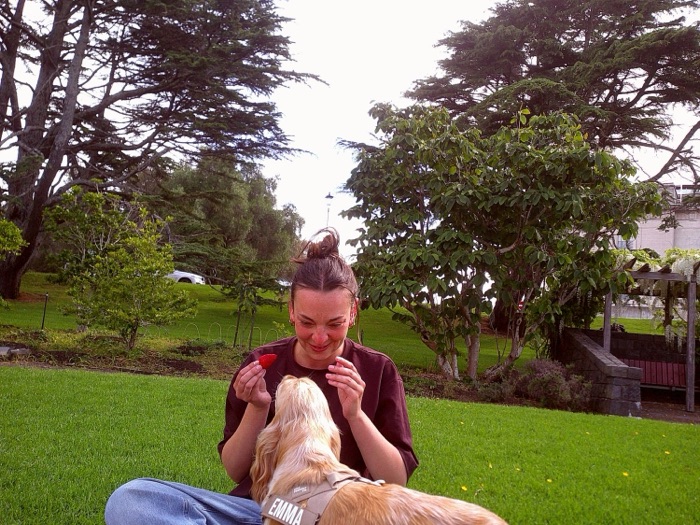 Sharing a strawberry with Emma the dog