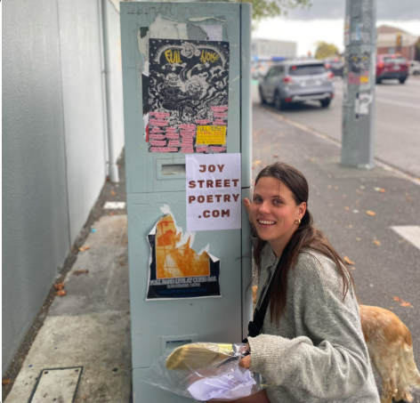 Me, pasting Joy Street Poetry posters around the city